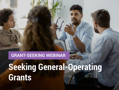 Grant-Seeking Webinar: Seeking General-Operating Grants - image of a team of professionals talking in a meeting room at a table