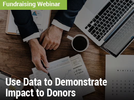 Fundraising Webinar: Use Data to Demonstrate Impact to Donors - image of a crowded desk with a laptop, coffee, and papers of charts